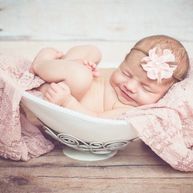 Das Bild zeigt ein Neugeborenes liebevoll in einer Belly Bowl aus einem Babybauch Gipsabdruck liegend. Die handgefertigte Bauchschale wurde als besonderes Fotoaccessoire für ein Babyshooting nach der Geburt verwendet und mit einem weichen Tuch sowie einem Haarband dekoriert. Die personalisierte Belly Bowl dient als emotionale Erinnerung an Schwangerschaft und Geburt und eignet sich ideal für professionelle Newborn-Fotografie – Veredelung als Alternative zur Ton Bauchschale - Atelier Body - pArts